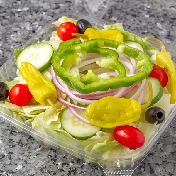 Fresh garden salad with lettuce, tomatoes, cucumbers, onions, bell peppers, olives, and pepperoncini.